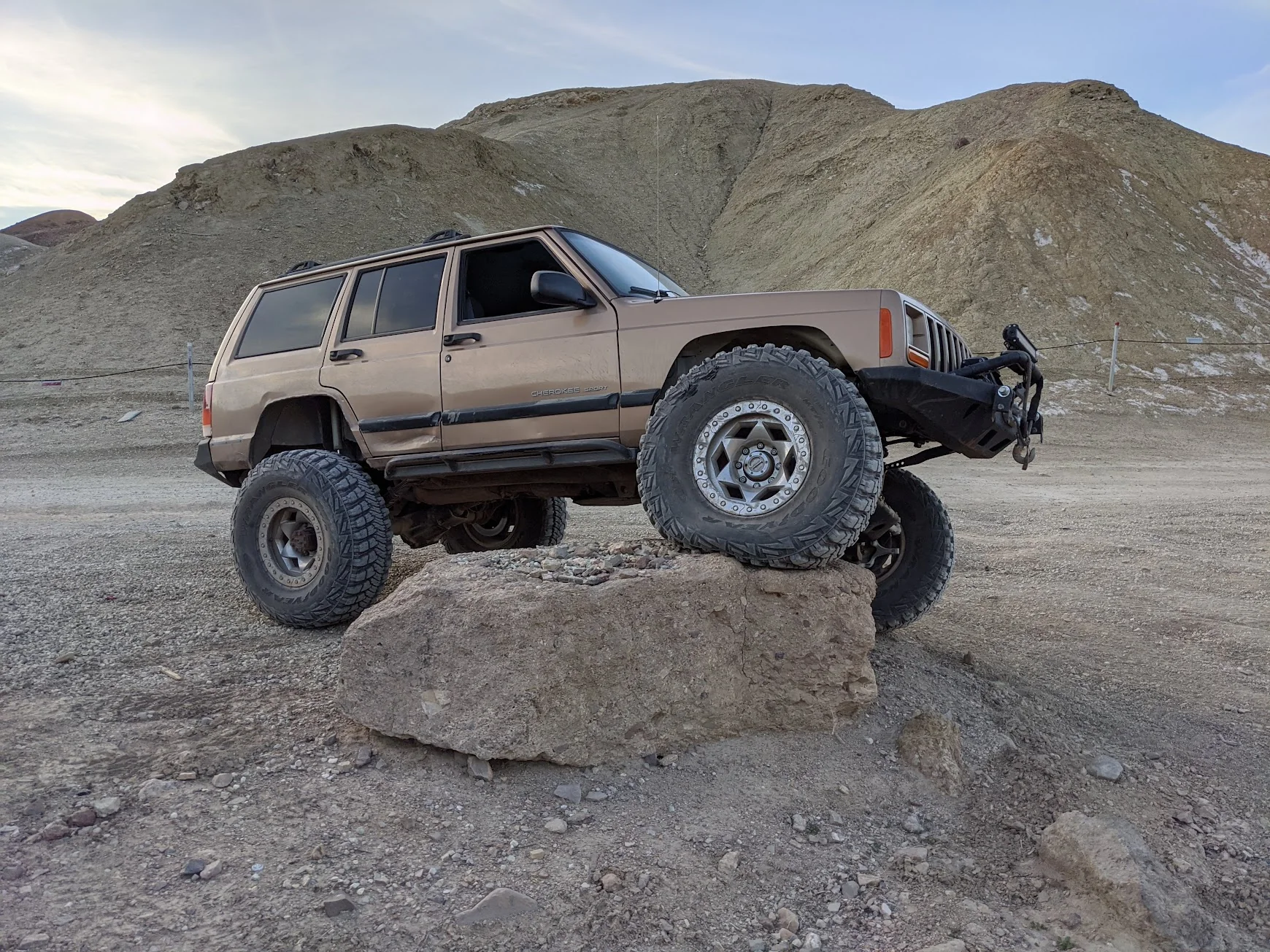 LS-swapped Jeep Cherokee climbing a rock formation